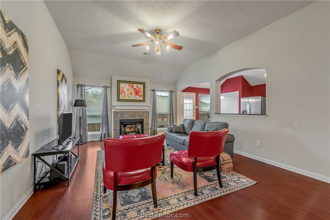 1027 Fallbrook Loop College Station, TX 77845 - Photo 6 of 20 a view of a livingroom with furniture a fireplace wooden floor and a chandelier
