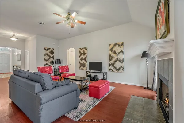 a living room with furniture and a fireplace