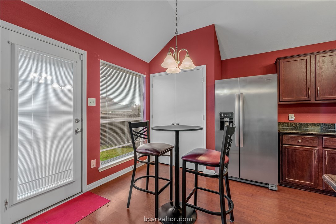 1027 Fallbrook Loop College Station, TX 77845 - Photo 8 of 20 a kitchen with stainless steel appliances a refrigerator a microwave a stove and wooden floor