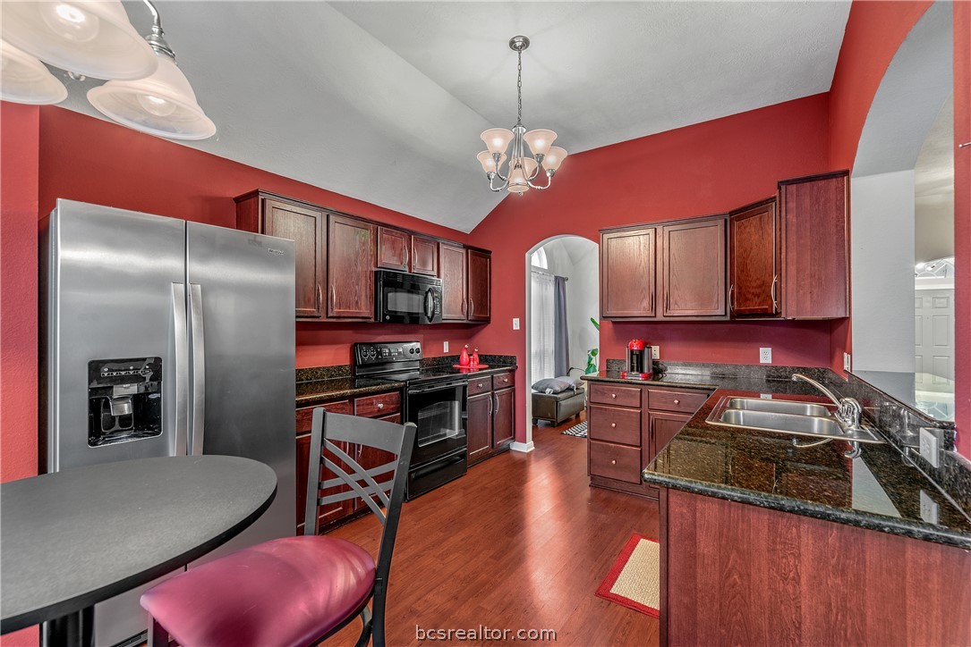 1027 Fallbrook Loop College Station, TX 77845 - Photo 9 of 20 a kitchen with stainless steel appliances granite countertop a stove refrigerator and microwave