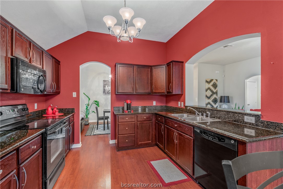 1027 Fallbrook Loop College Station, TX 77845 - Photo 10 of 20 a kitchen with stainless steel appliances a sink stove and cabinets