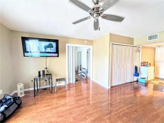 a living room with furniture and a large window with wooden floor