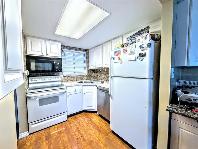 a white refrigerator freezer sitting in a kitchen