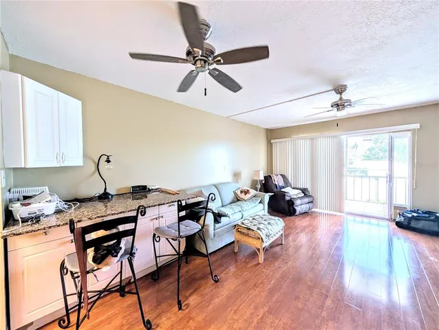 a living room with furniture a window and a chandelier