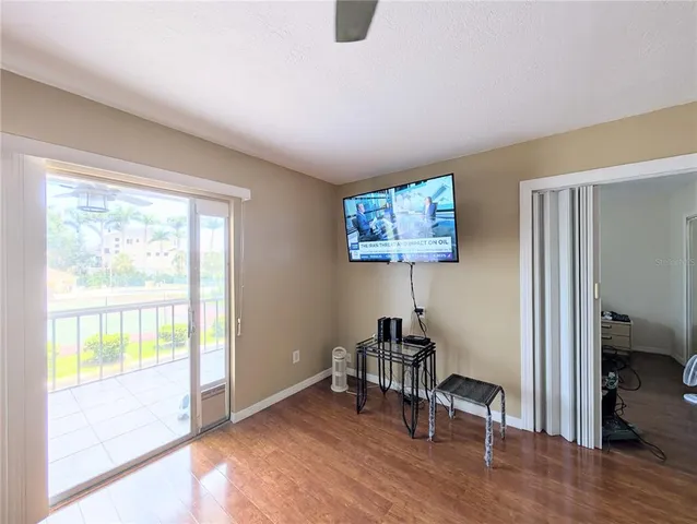 a view of a livingroom with workspace and a ceiling fan