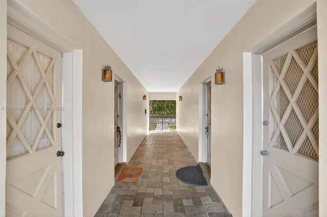 a view of a hallway with wooden walls