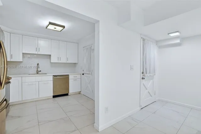 a white refrigerator freezer and a stove in a kitchen