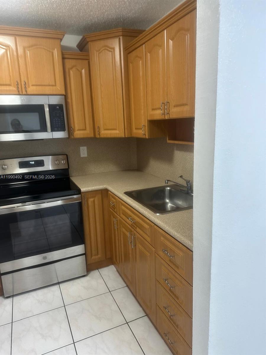 2565 West 56th Street, Unit 209 Hialeah, FL 33016 - Photo 3 of 10 a kitchen with a sink and cabinets