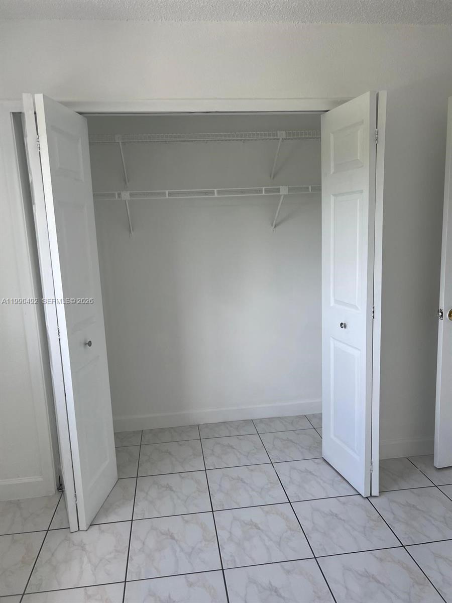 2565 West 56th Street, Unit 209 Hialeah, FL 33016 - Photo 9 of 10 a view of an empty walk in closet