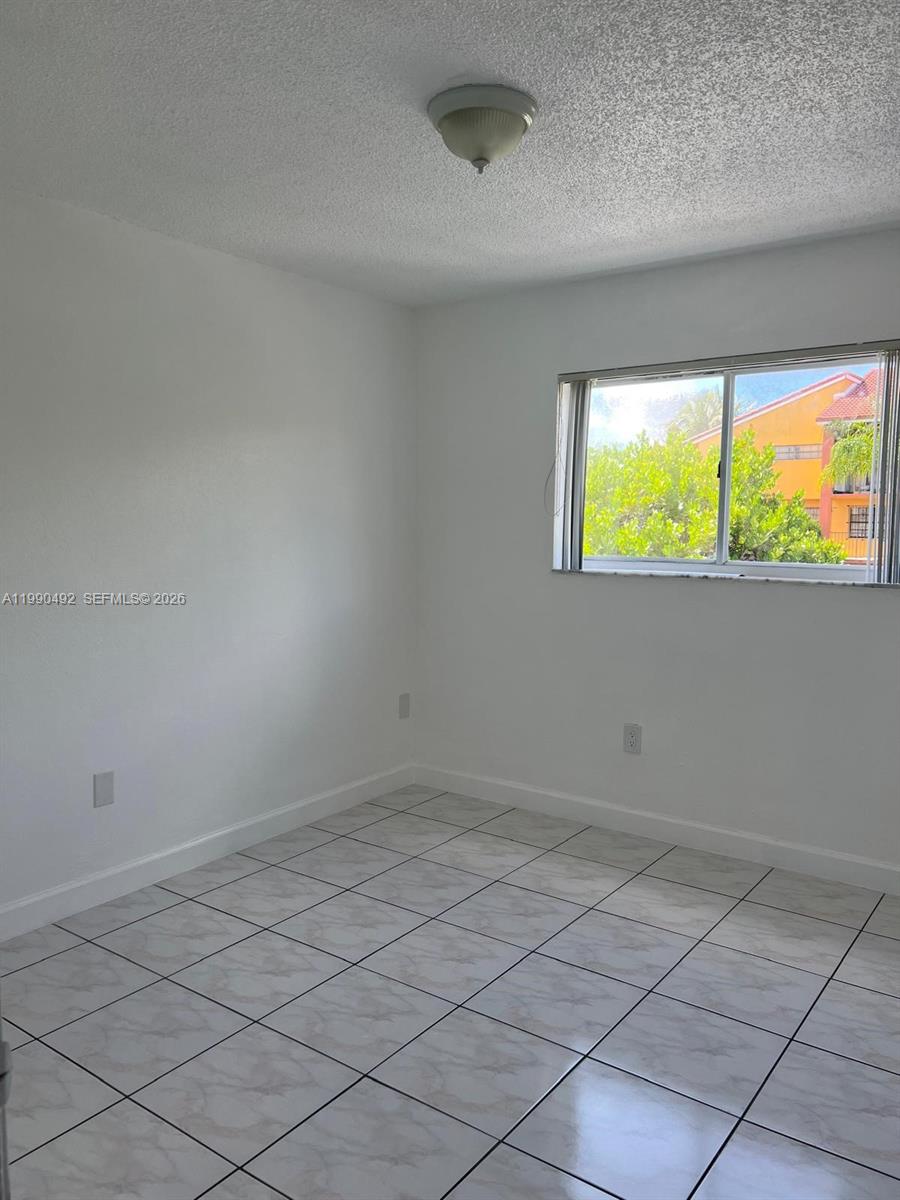 2565 West 56th Street, Unit 209 Hialeah, FL 33016 - Photo 10 of 10 a view of an empty room and window