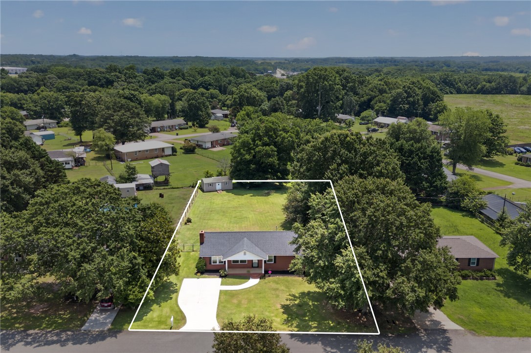 113 Greenfield Avenue Pendleton, SC 29670 - Photo 31 of 40 Aerial view highlights the property's generous lot, with mature trees providing shade to the neatly maintained lawn.