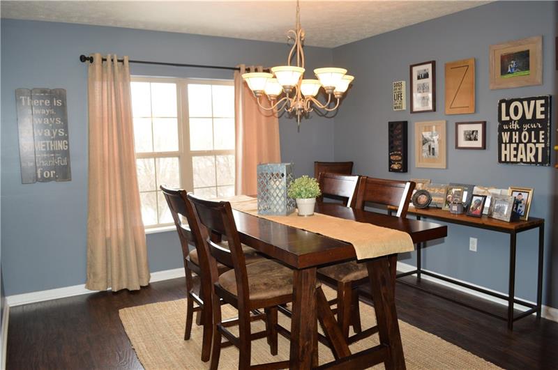 212 Grace Street McKees Rocks, PA 15136 - Photo 6 of 25 Tastefully updated dining room with plenty of space and beautiful, laminate wood flooring.