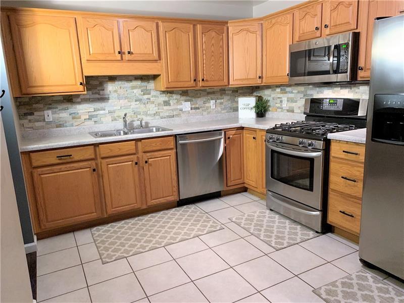 212 Grace Street McKees Rocks, PA 15136 - Photo 9 of 25 Updated and spacious kitchen flows into the dining room.