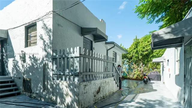 a view of a house with a small yard and plants