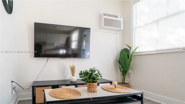 a living room with furniture and a flat screen
