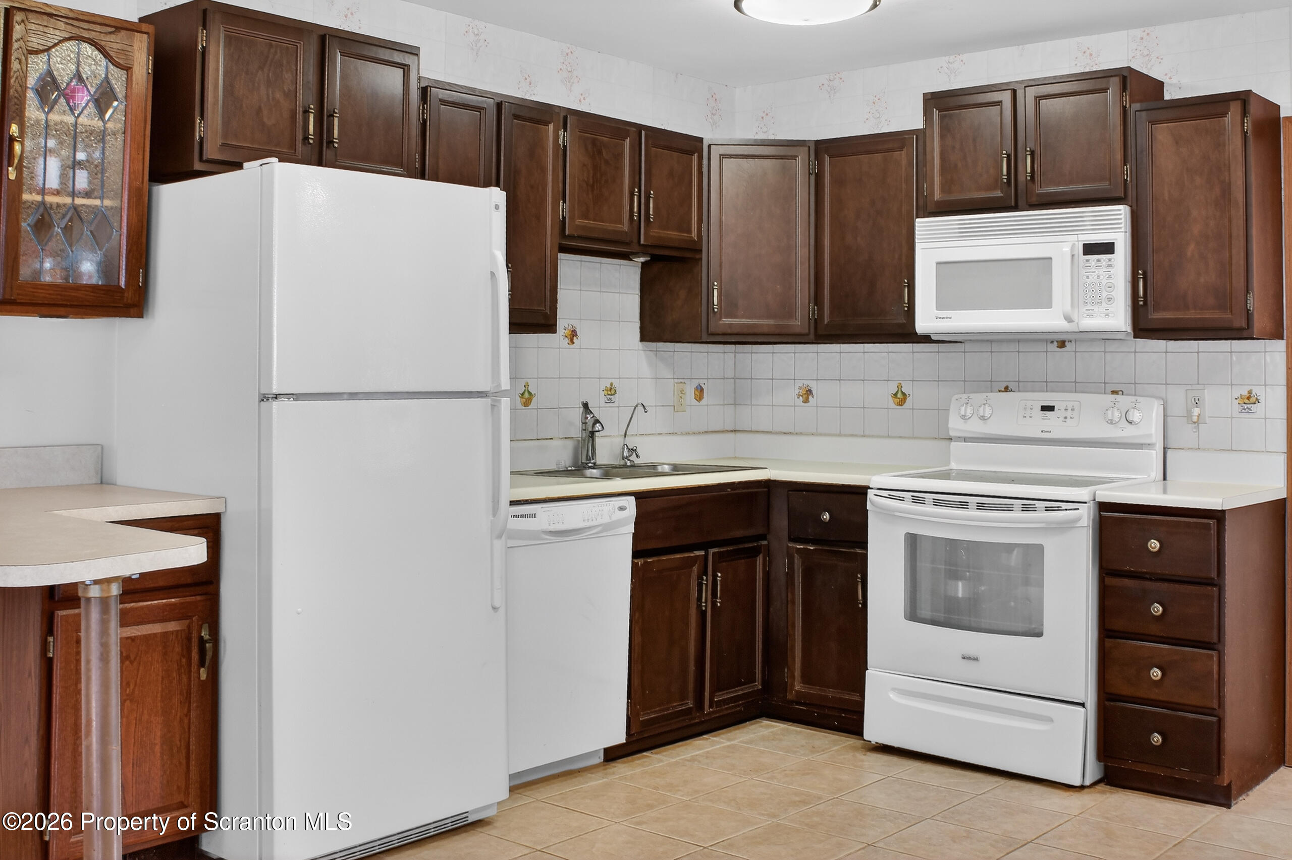 211 Falls Circle Bushkill, PA 18324 - Photo 3 of 28 a white refrigerator freezer sitting in a kitchen