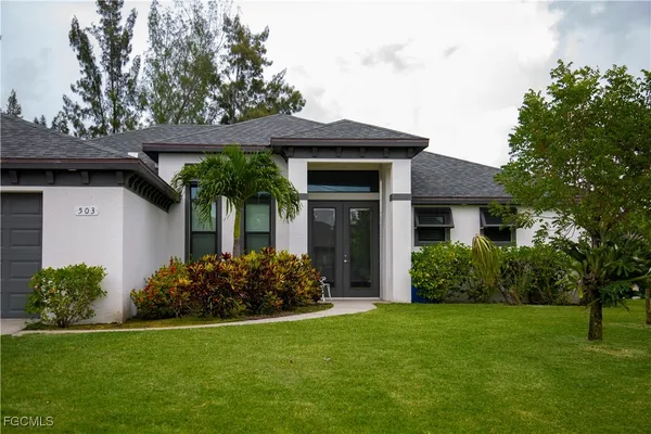 a front view of a house with garden