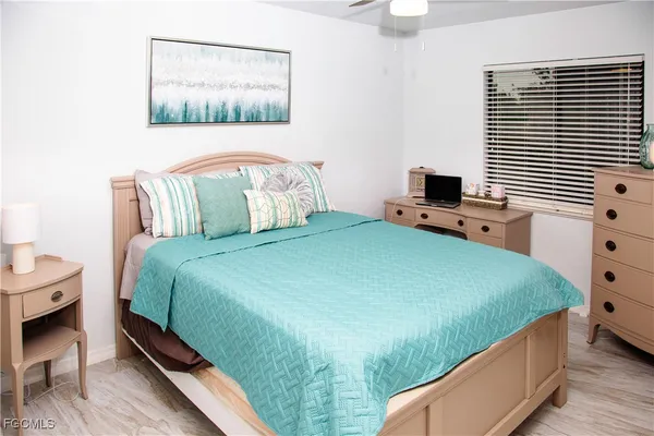 a bedroom with a bed and a tv on the dresser