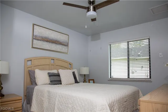 a bedroom with a large bed and a window