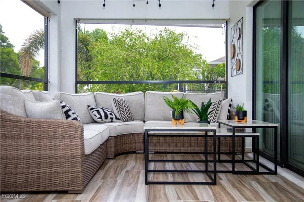 a living room with furniture and a large window