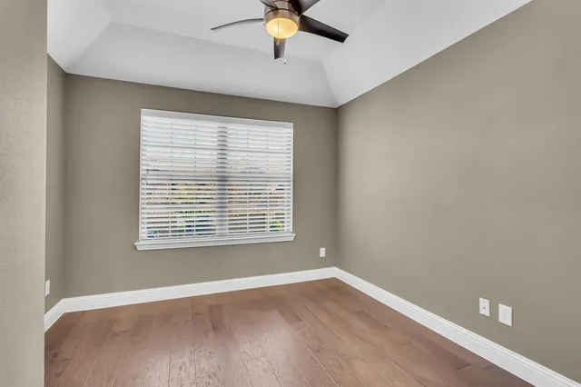 a bathroom with a granite countertop toilet sink and mirror