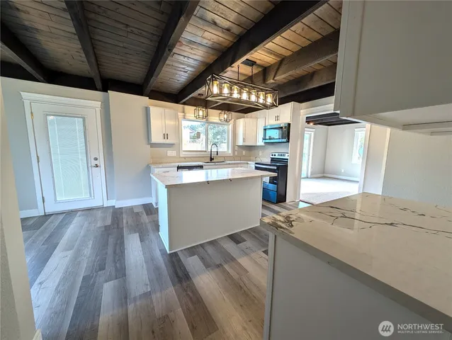 a open kitchen with a stove a sink dishwasher and a refrigerator