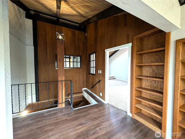 a view of an empty room with a window and fireplace