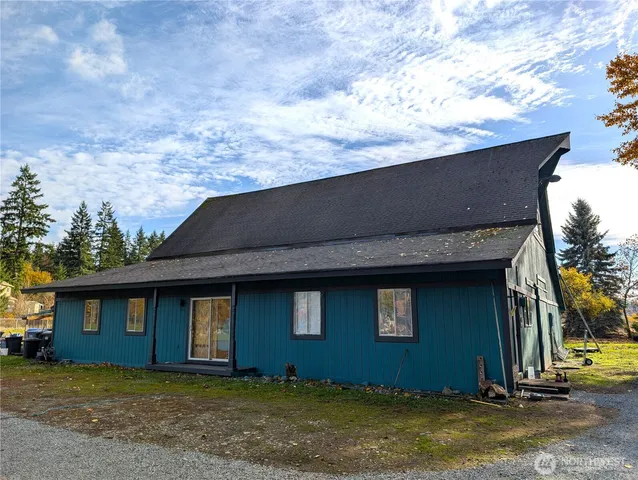 a pathway of a house with a yard and a wooden fence