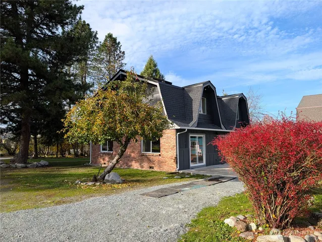 a open kitchen with a sink a stove and wooden floors