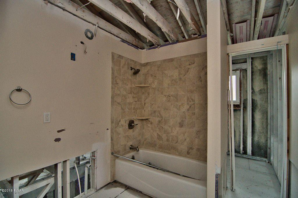 387 Robinson Road Waymart, PA 18472 - Photo 8 of 30 a bathroom with a bathtub and a shower