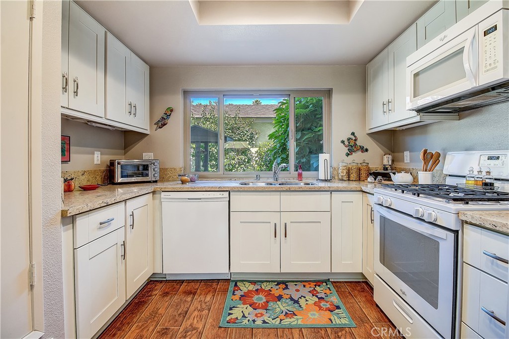 6618 Wintertree Drive Riverside, CA 92506 - Photo 13 of 37 a kitchen with stainless steel appliances granite countertop a stove a sink and cabinets
