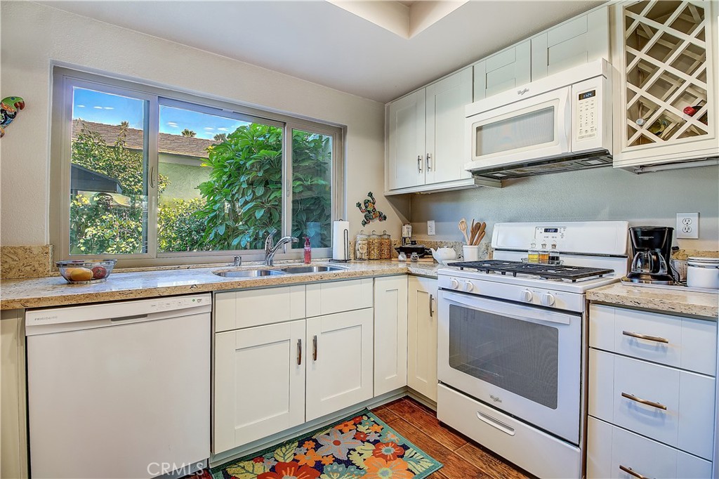 6618 Wintertree Drive Riverside, CA 92506 - Photo 14 of 37 a kitchen with stainless steel appliances granite countertop a sink a stove and cabinets