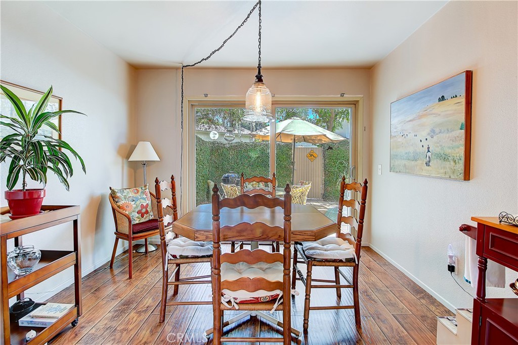 6618 Wintertree Drive Riverside, CA 92506 - Photo 18 of 37 a dining room with furniture a chandelier and wooden floor