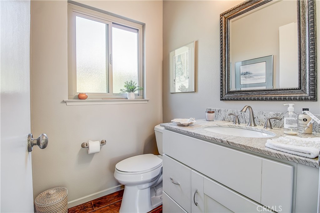 6618 Wintertree Drive Riverside, CA 92506 - Photo 19 of 37 a bathroom with a granite countertop toilet sink and mirror