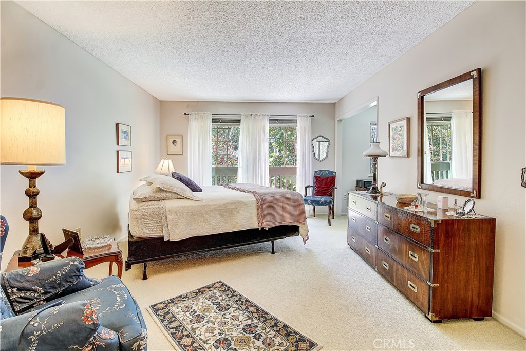 6618 Wintertree Drive Riverside, CA 92506 - Photo 21 of 37 a spacious bedroom with a bed and wooden floor