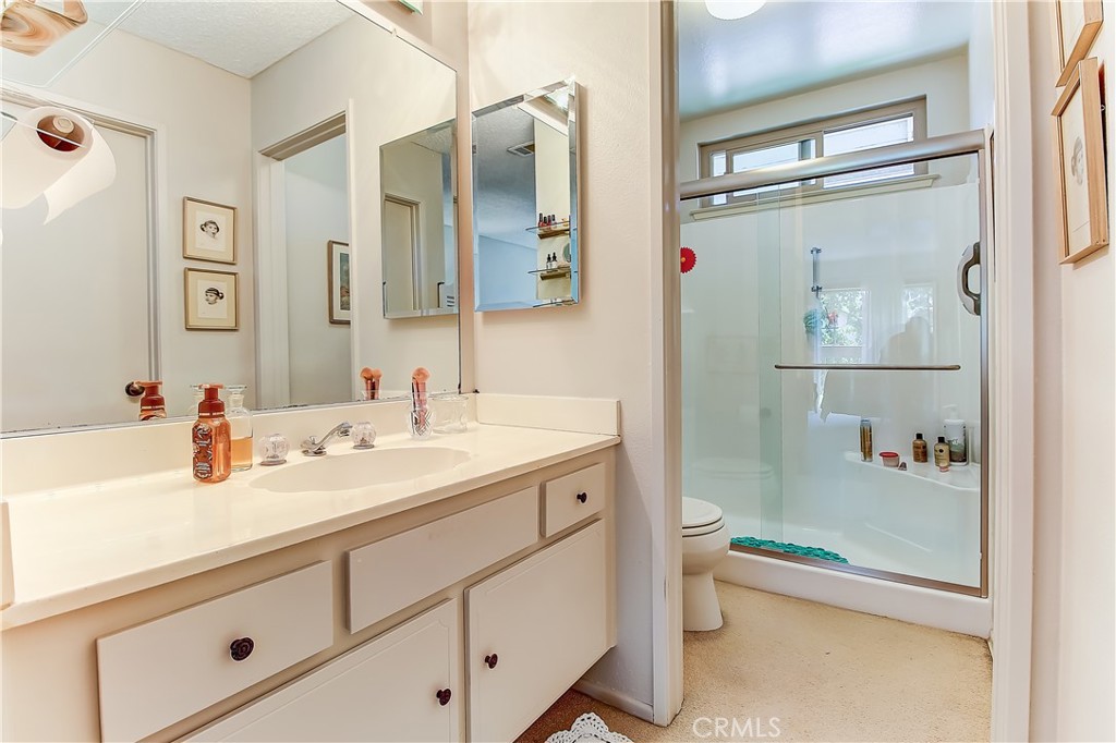 6618 Wintertree Drive Riverside, CA 92506 - Photo 25 of 37 a bathroom with a granite countertop sink mirror and toilet