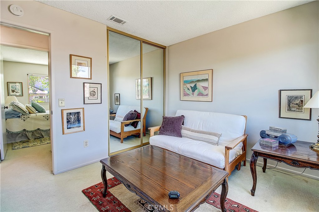 6618 Wintertree Drive Riverside, CA 92506 - Photo 27 of 37 a living room with furniture and paintings on the wall