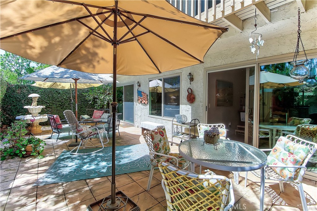 6618 Wintertree Drive Riverside, CA 92506 - Photo 32 of 37 a view of a patio with table and chairs under an umbrella