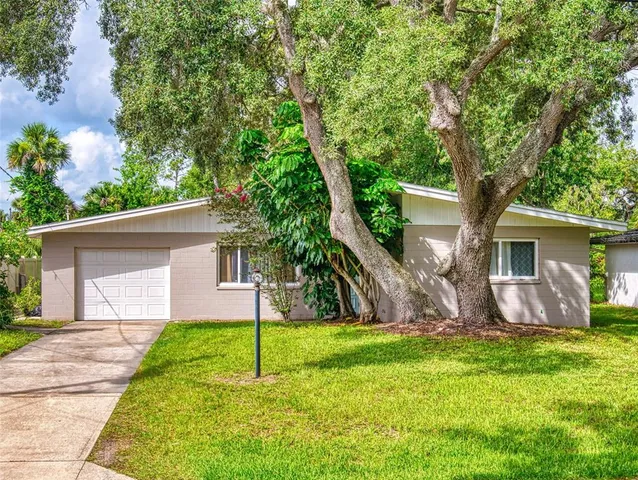 a house view with a sitting space and garden