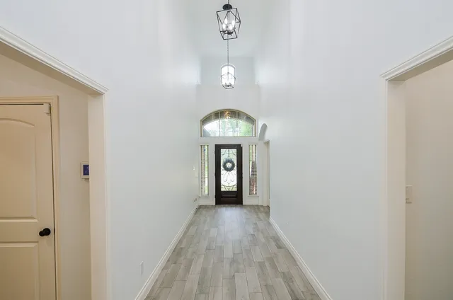 a living room with furniture a flat screen tv and a large window