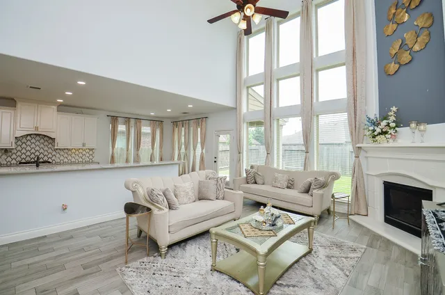 a living room with furniture a fireplace and a flat screen tv