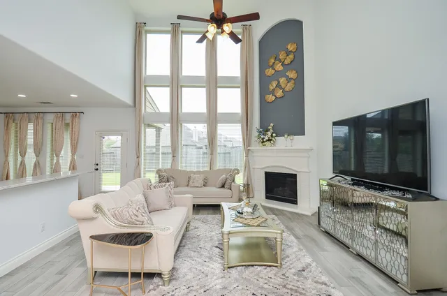 a large white kitchen with stainless steel appliances granite countertop a stove a sink and a refrigerator