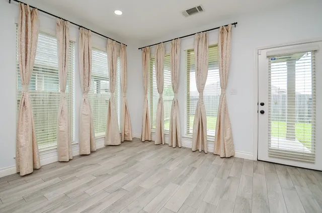 a view of an empty room with large windows