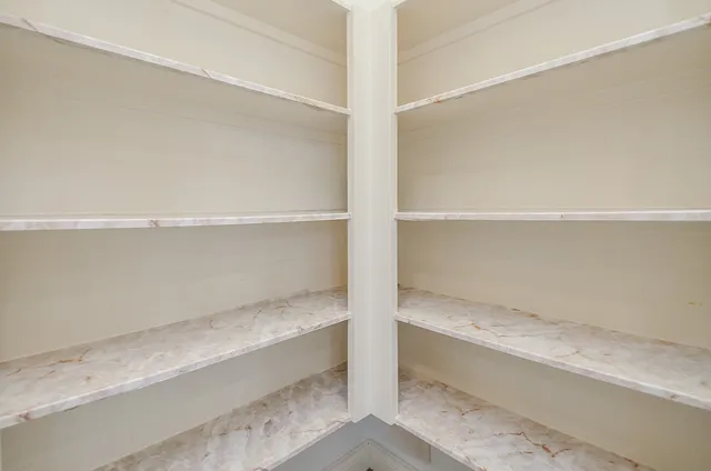 a view of a room with wooden floor and windows