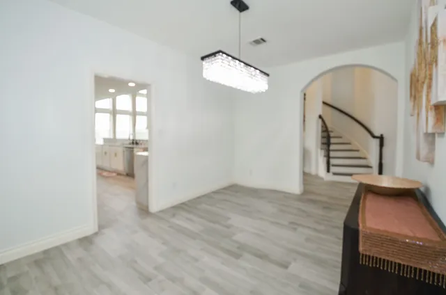 a spacious bedroom with a bed and large window