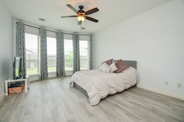 a bathroom with a granite countertop double vanity sink a mirror and a bathtub
