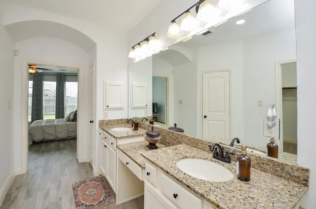 a white bath tub sitting next to a shower