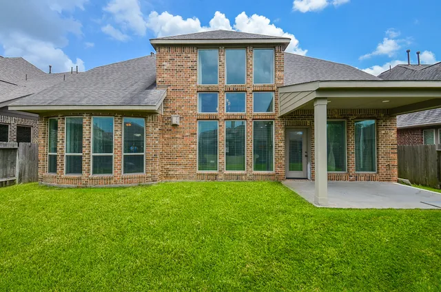 a view of a backyard with a garden and wooden fence