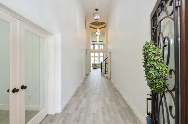 a view of a hallway to a livingroom with wooden floor