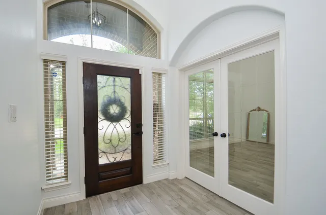 a view of a room with wooden floor and windows